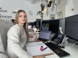 Caitlin sitting at her desk