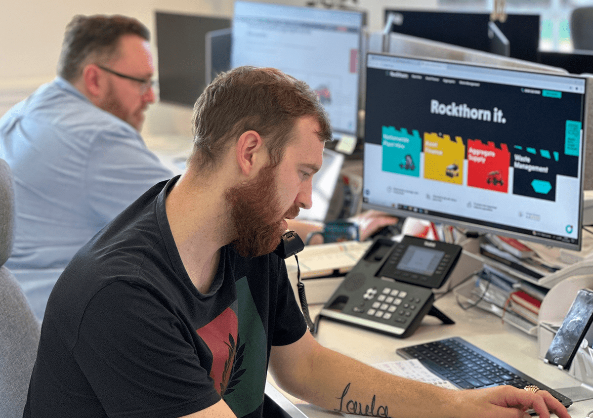 Man working at computer while on the phone