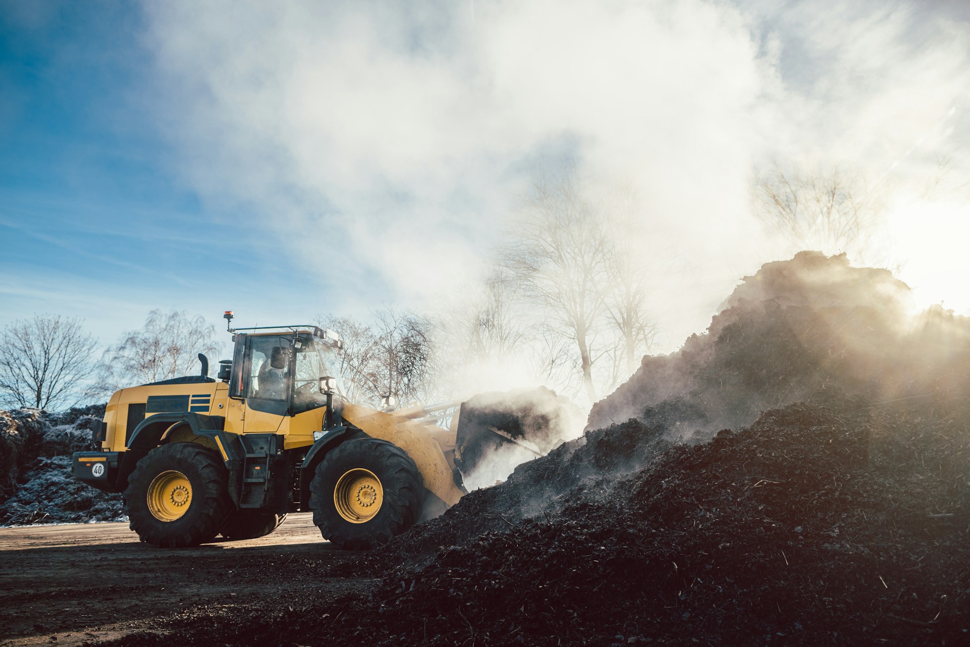 Plant machine tipping dirt into a pile