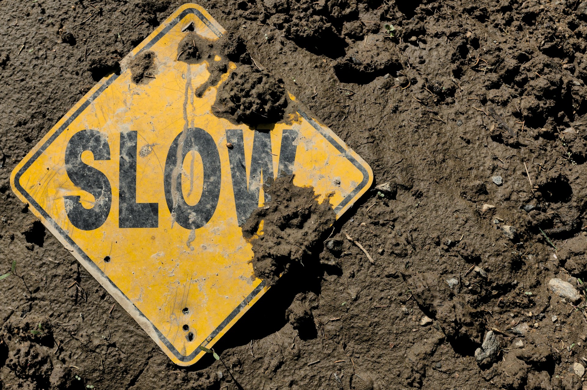 Slow hazard sign in the mud